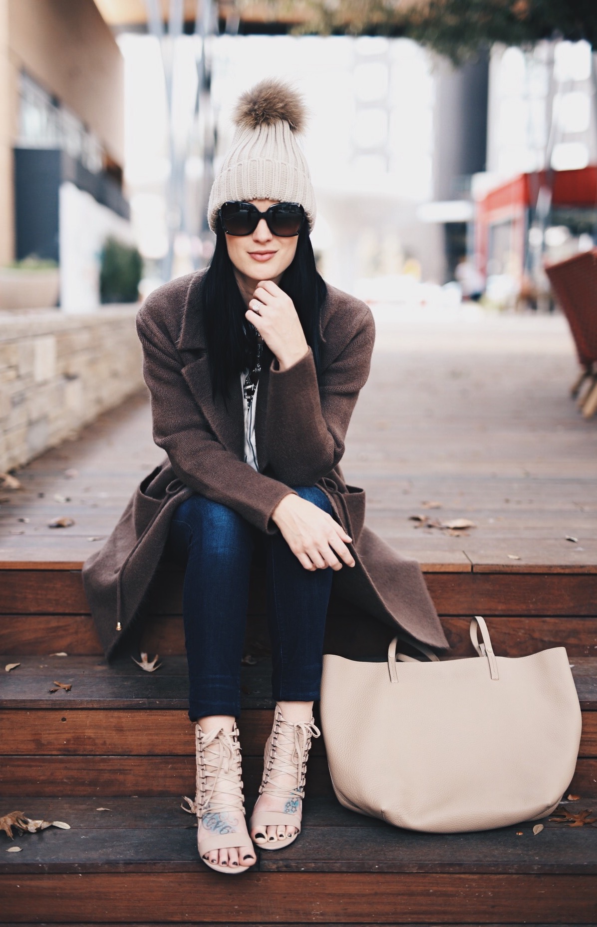 Ashley of DTKAustin is wearing a Chicwish coat with Lace up pumps from Revolve and a Gigi New York Tote.