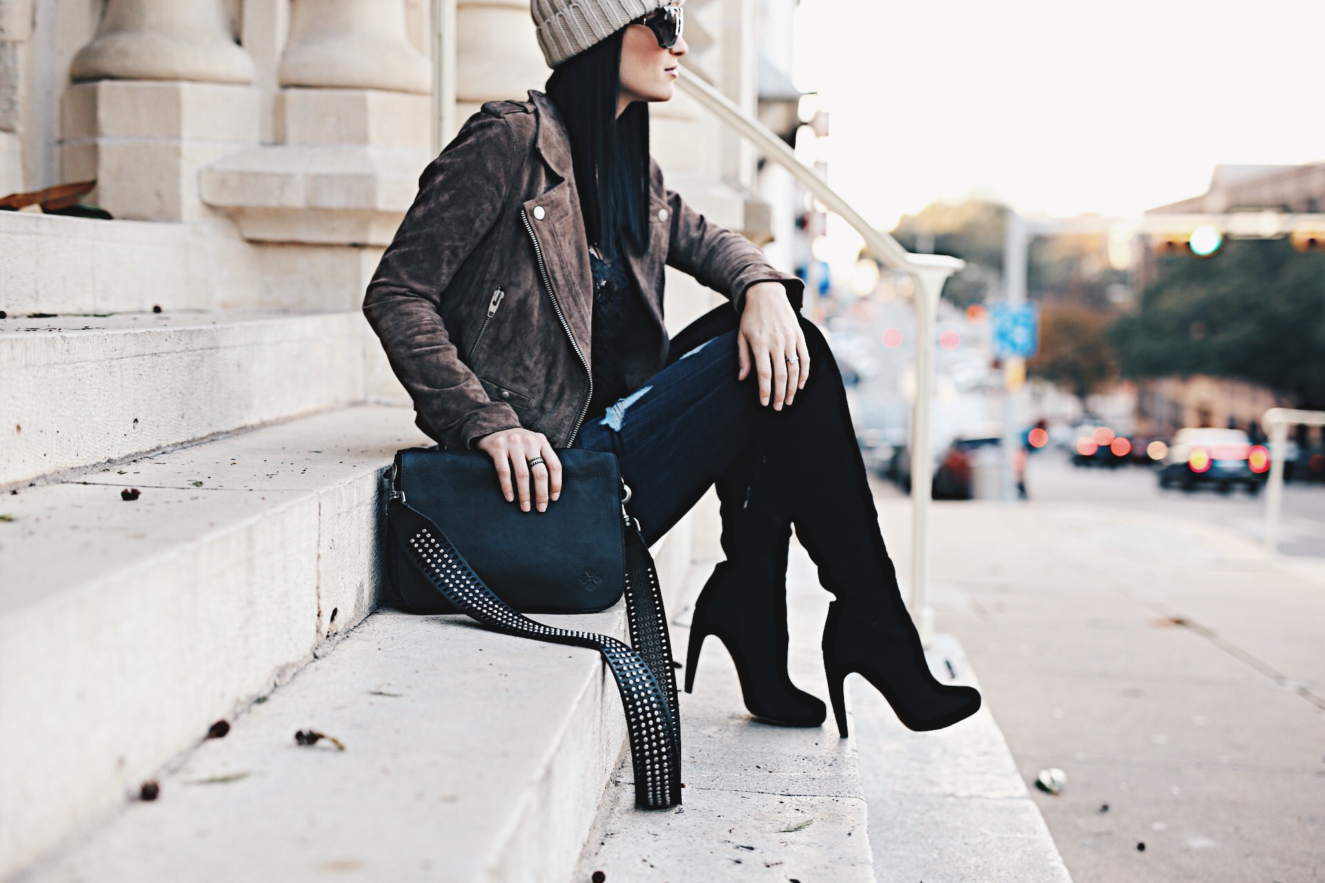 Ashley Hargrove of DTKAustin is wearing a Patricia Nash leather crossbody from Macy's, Steve Madden over the knee boots and a BlankNYC leather jacket from Nordstrom.