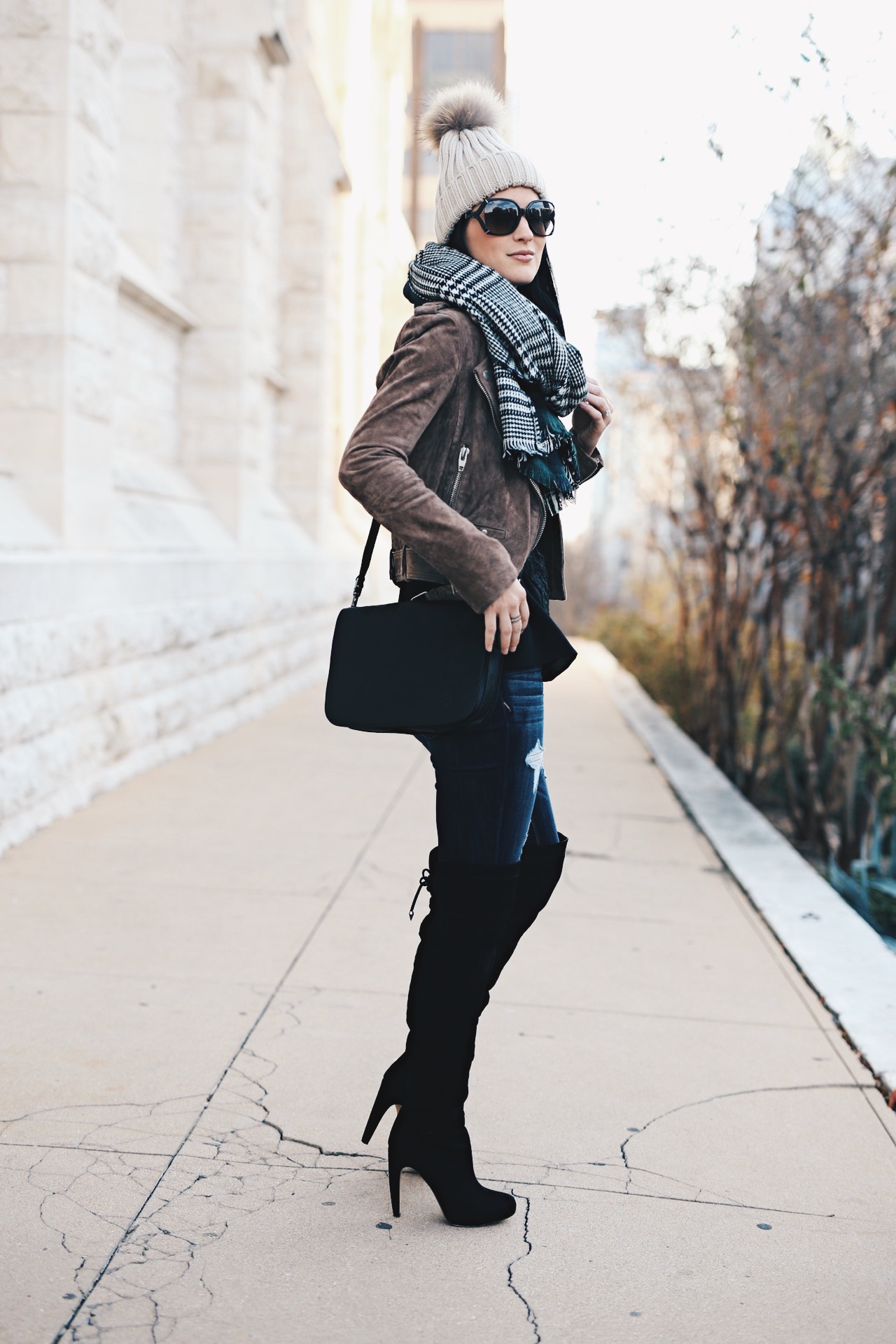 Ashley Hargrove of DTKAustin is wearing a Patricia Nash leather crossbody from Macy's, Steve Madden over the knee boots and a BlankNYC leather jacket from Nordstrom.