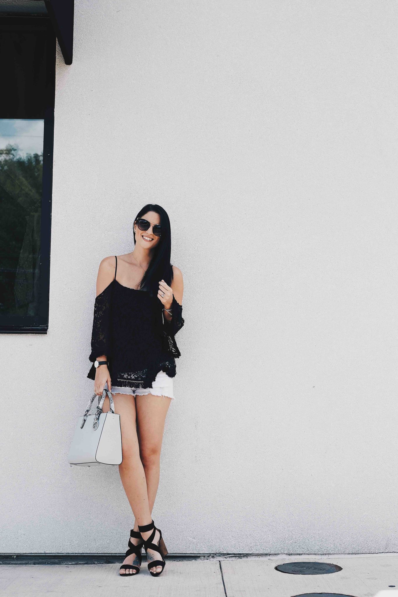 DTKAustin shares a beautiful black Bailey44 lace cold shoulder top, paired with white cutoff shorts, a Henri Bendel bag and Splendid black heels. Click for more information and photos. | how to style a cold shoulder top | how to wear a cold shoulder top | cold shoulder top style tips | summer fashion tips | summer outfit ideas | summer style tips | what to wear for summer | warm weather fashion | fashion for summer | style tips for summer | outfit ideas for summer || Dressed to Kill