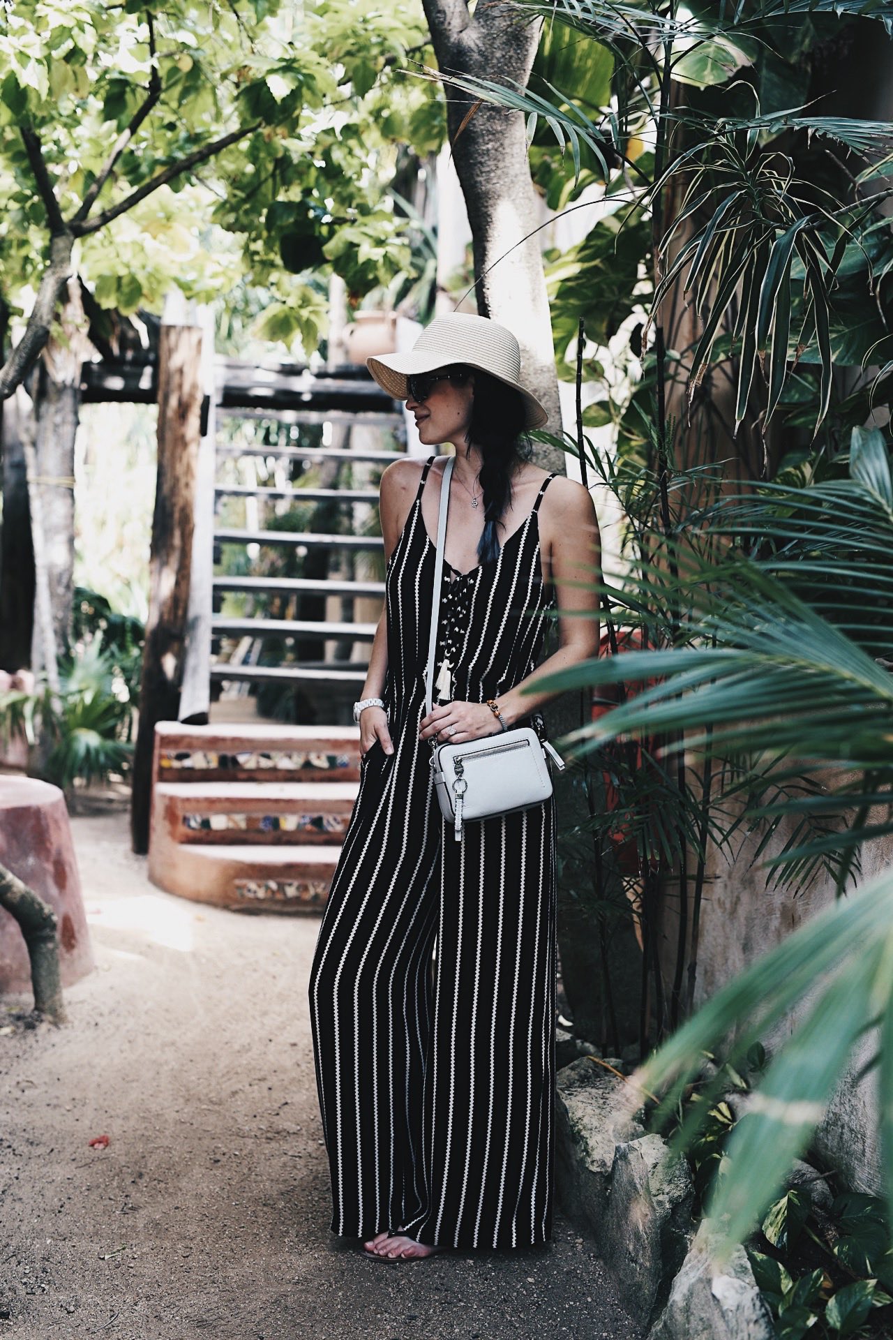 DTKAustin shares some of her recent photos from Tulum, Mexico with ideas on what to wear to beat the heat in the jungle or on the beach. Jumpsuit from Wala Swim, Bag from Henri Bendel. Click for more images and information. | how to style a jumpsuit | how to wear a jumpsuit | jumpsuit styling tips | summer fashion tips | summer outfit ideas | summer style tips | what to wear for summer | warm weather fashion | fashion for summer | style tips for summer | outfit ideas for summer || Dressed to Kill
