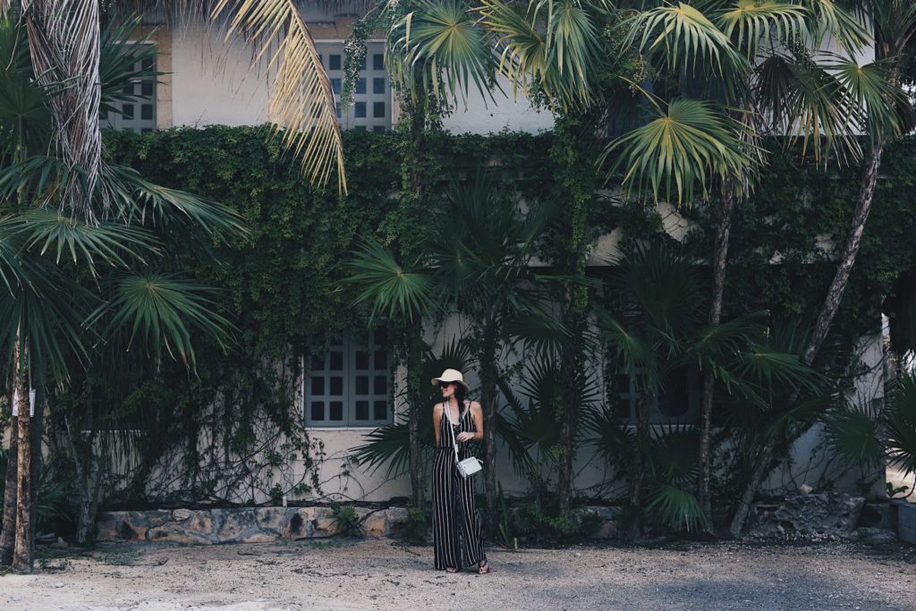 DTKAustin shares some of her recent photos from Tulum, Mexico with ideas on what to wear to beat the heat in the jungle or on the beach. Jumpsuit from Wala Swim, Bag from Henri Bendel. Click for more images and information.