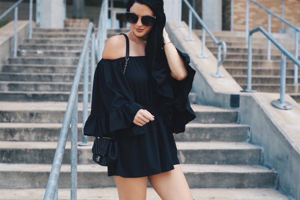 Austin Blogger DTKAustin is sharing this Chicwish black off-the-shoulder romper with fabulous ruffle detailing. Under $100 and the perfect piece to transition into Fall with a cute pair of OTK, over-the-knee boots. Click for more details and photos.