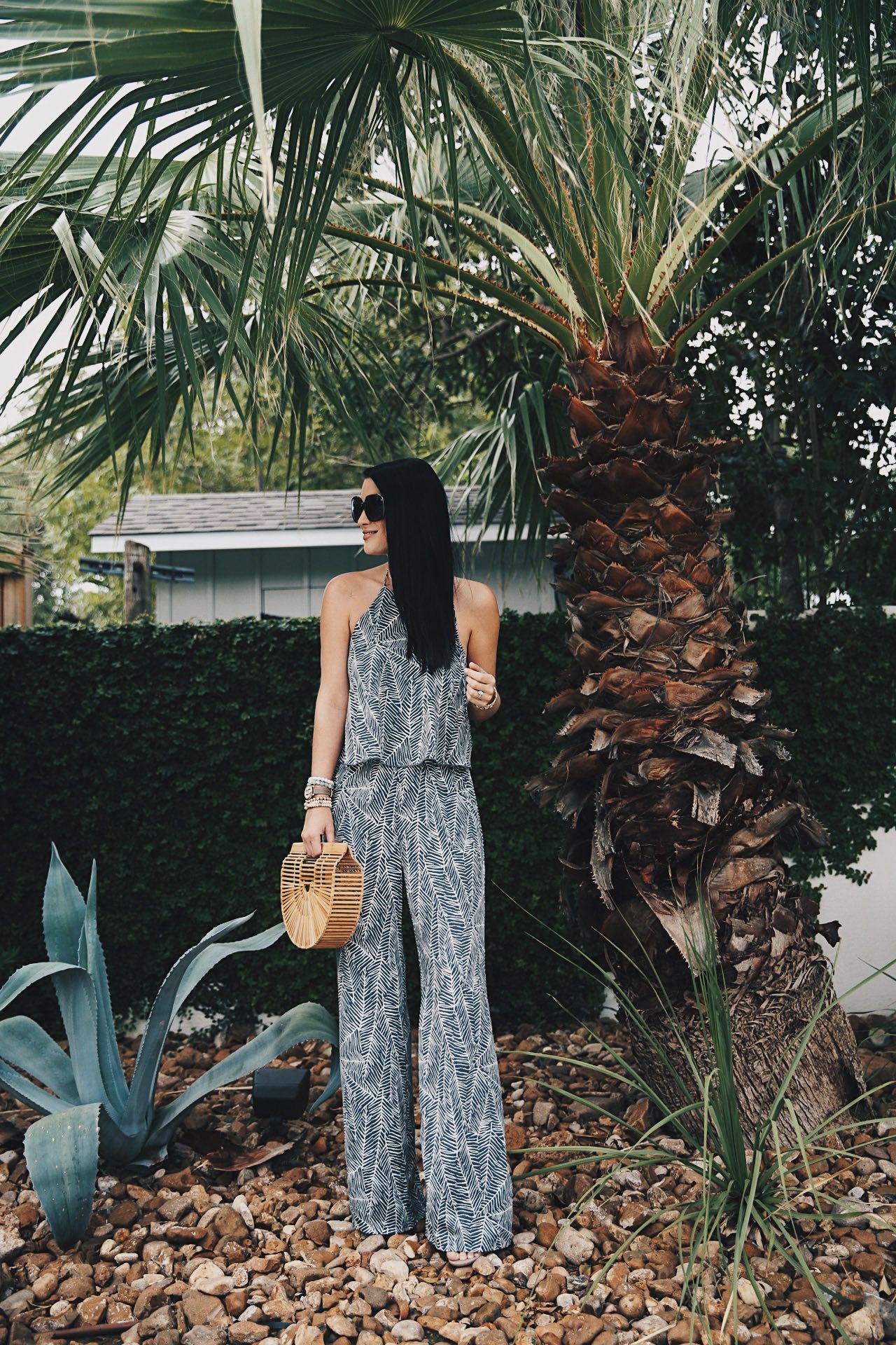 DTKAustin shares details on one of her go-to women's boutiques; Red Dress Boutique along with this beautiful palm print jumpsuit and Japanese bamboo bag. | how to style a jumpsuit | how to wear a jumpsuit | fall fashion tips | fall outfit ideas | fall style tips | what to wear for fall | cool weather fashion | fashion for fall | style tips for fall | outfit ideas for fall || Dressed to Kill