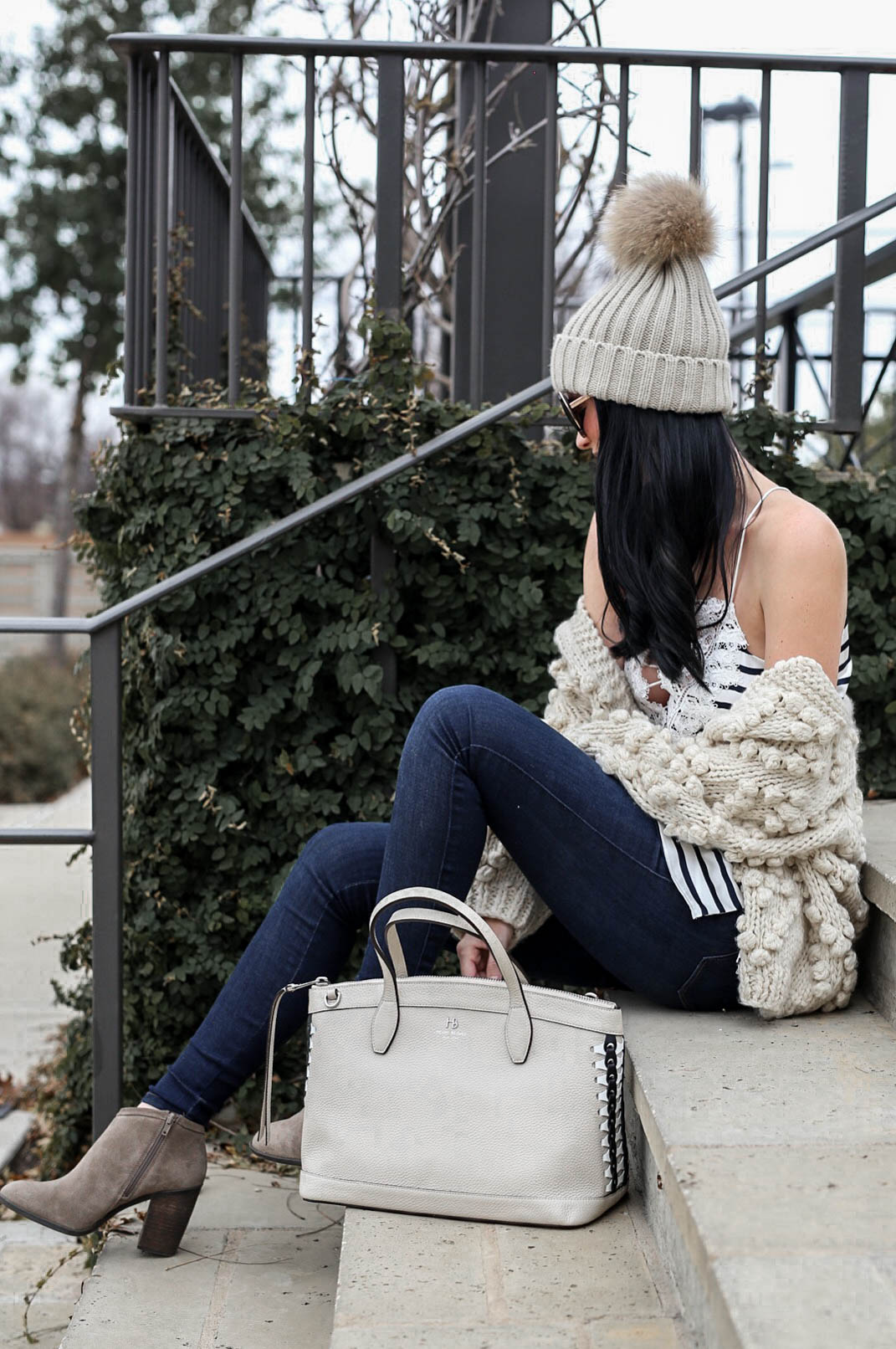Wardrobe Staples featured by top US fashion blog Dressed to Kill; Image of a woman wearing Chicwish cardigan, CamiNYC cami, Mott & Bow jeans, Lucky booties, Henri Bendel handbag, T&J Designs beanie and Nordstrom sunglasses.