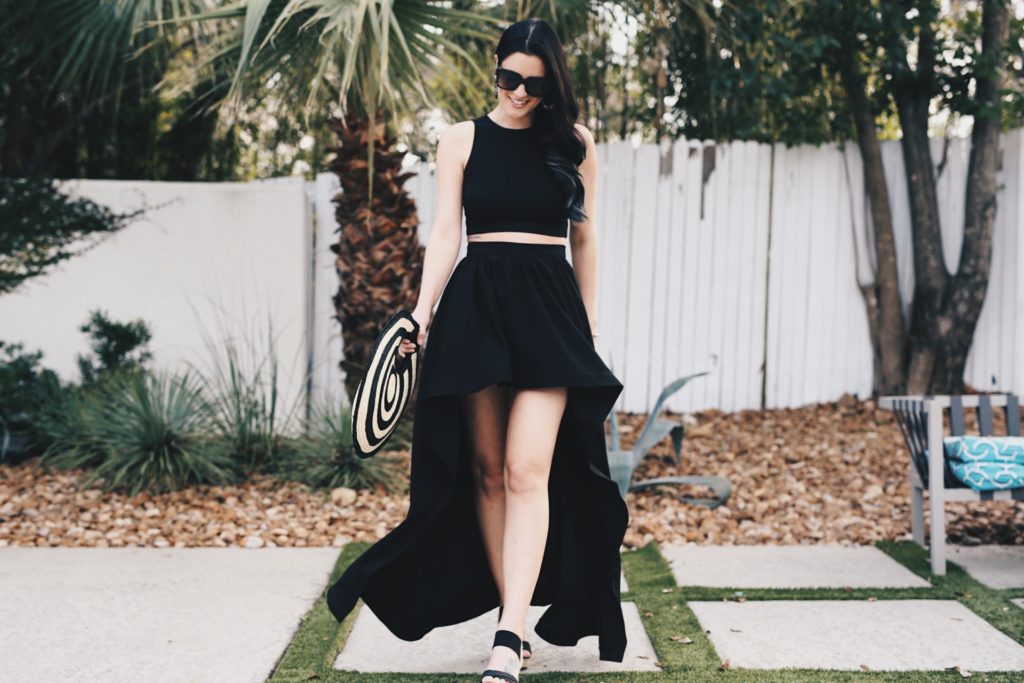 DTKAustin shares one of her most dramatic summer looks; a back two piece, high low skirt set from Akira with a straw round bag from Anthropologie. - Akira Clothing outfit styled by popular Austin fashion blogger Dressed to Kill