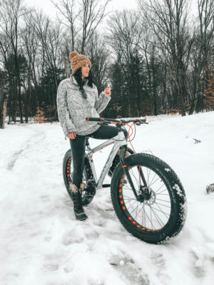 The Rosseau Muskoka featured by top US travel blog Dressed to Kill; Girl riding a bike in the snow.