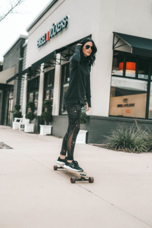 Affordable Activewear featured by top US fashion blog Dressed to Kill; Women wearing Walmart workout legging riding a long board.