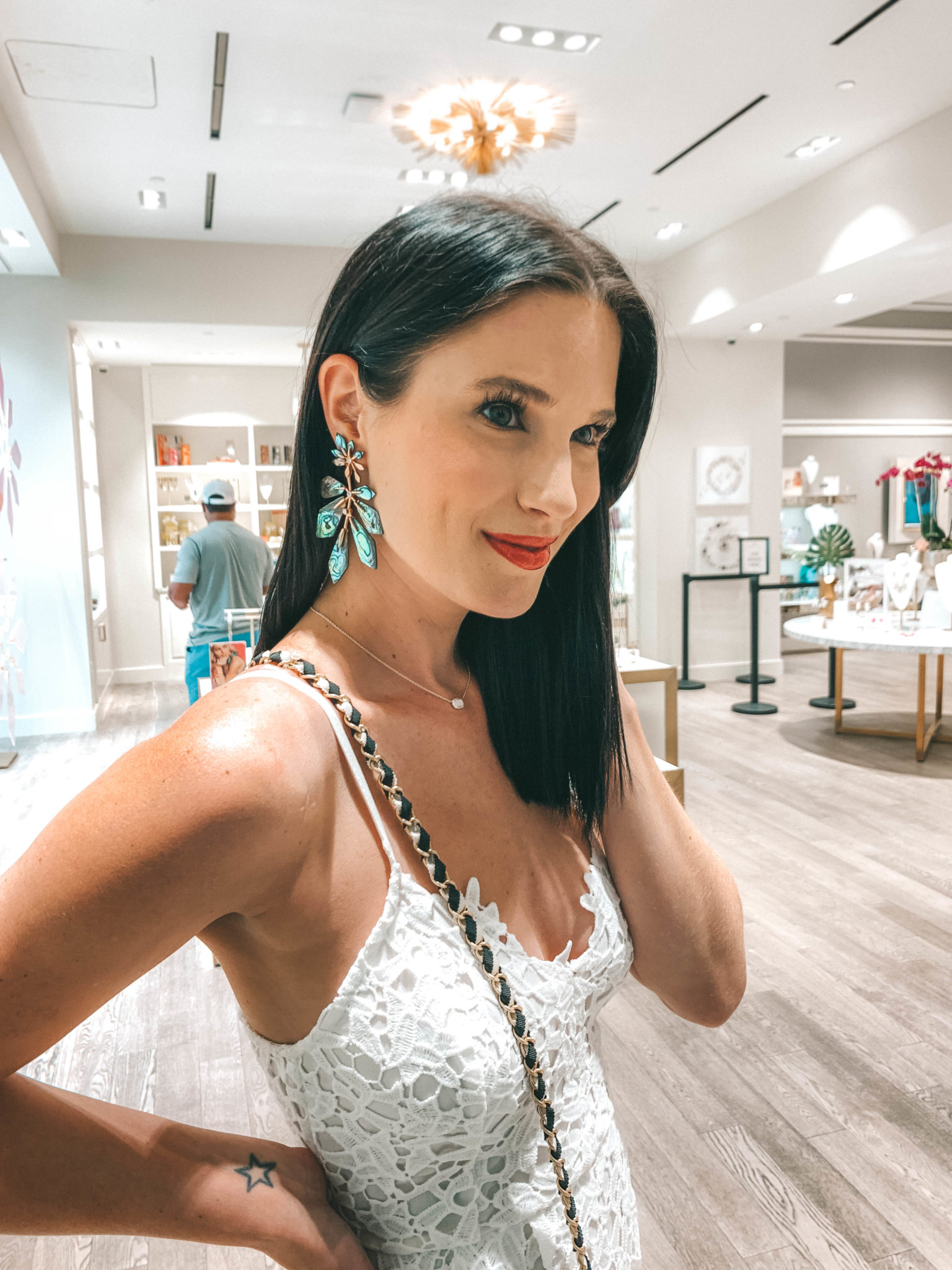 Unique Mother's Day Gift Ideas featured by top US life and style blogger Dressed to Kill; Image of a woman wearing a white lace dress.