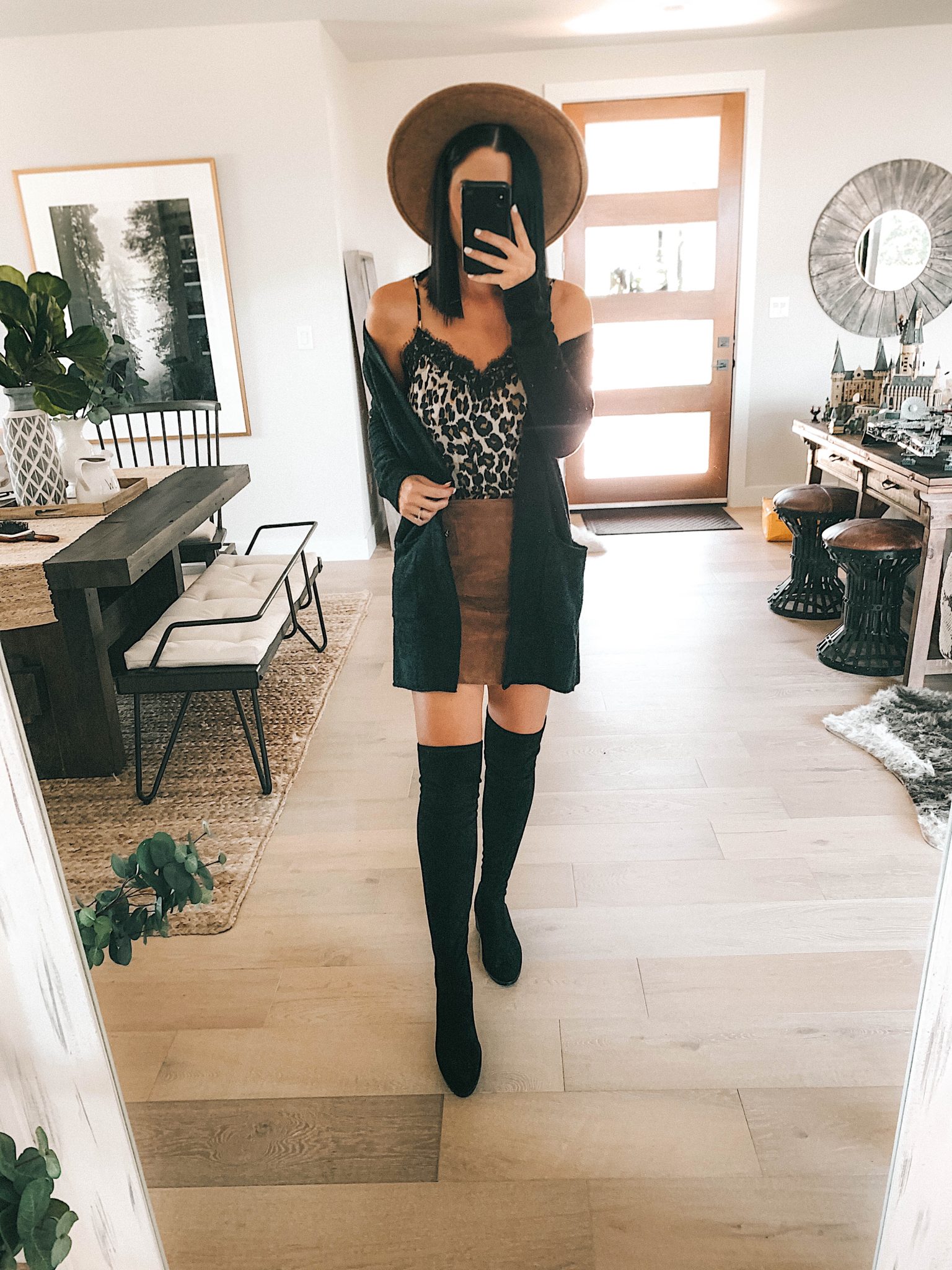 Create a Capsule Wardrobe with Nordstrom Anniversary Sale Pieces by popular Austin fashion blog, Dressed to Kill: image of a woman standing in her house and wearing a Nordstrom BlankNYC Suede Mini Skirt, Barefoot Dreams Cardigan, Steve Madden Over the Knee Boots and BP Lace Cami. 