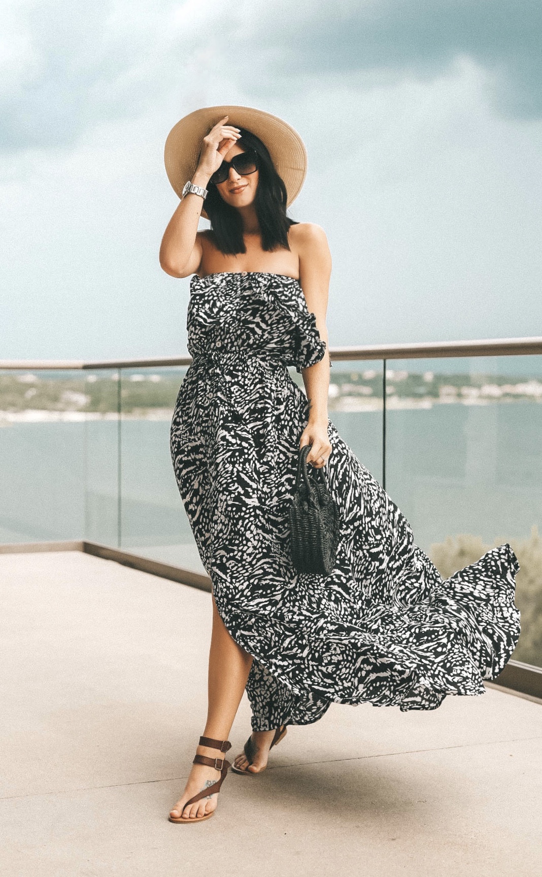 5 Affordable Summer Outfits from Walmart by popular Austin fashion blog, Dressed to Kill: image of a woman standing outside on a balcony wearing a Walmart Sofia Jeans By Sofia Vergara Strapless Maxi Dress Women's. 