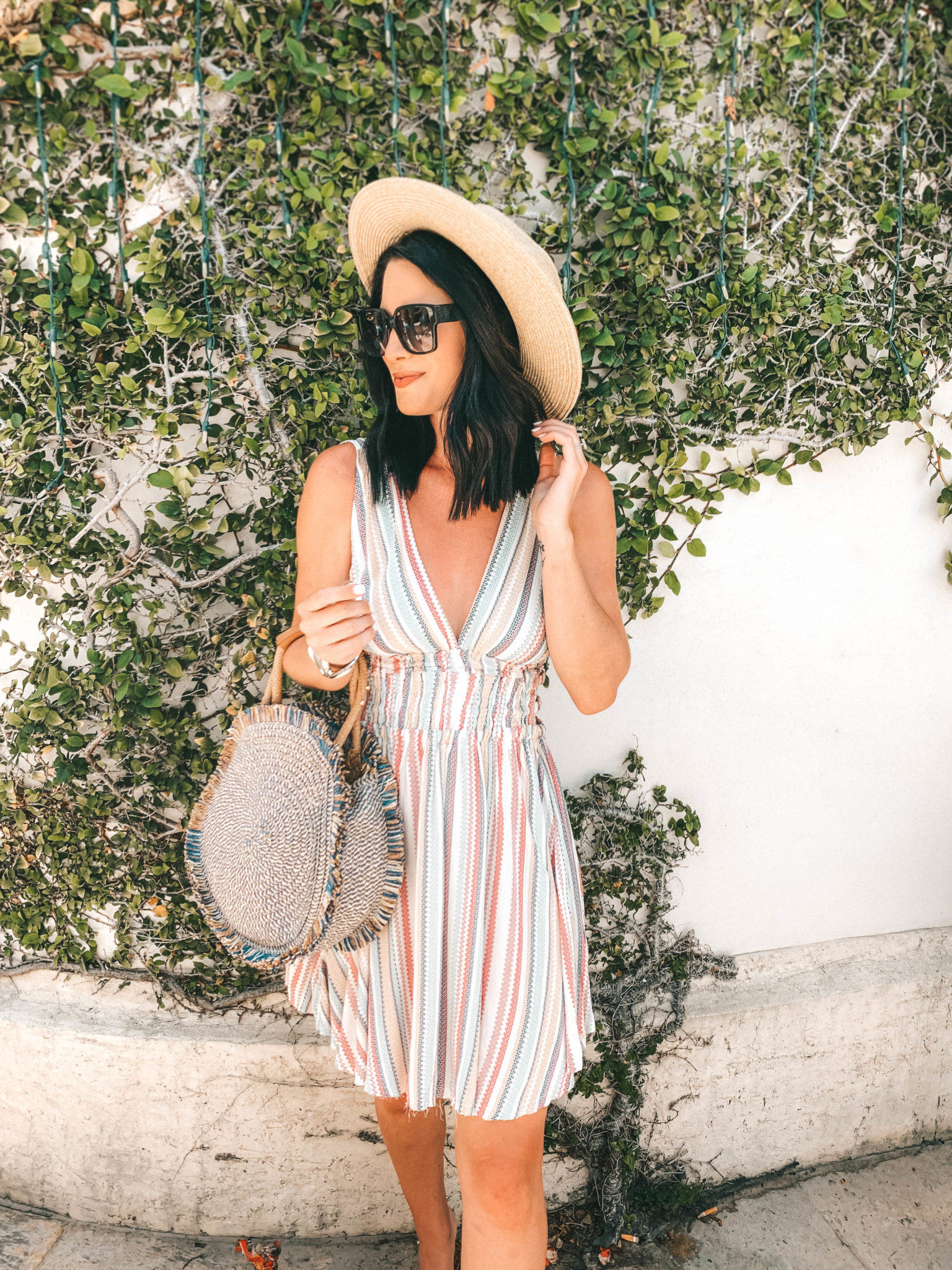 Amaryllis Apparel Abroad Turks & Caicos Summer Try-On by popular Austin fashion blog, Dressed to Kill: image of a woman standing outside in Turk and Caicos and wearing a striped Amaryllis Apparel Sorrento Stripe Dress.