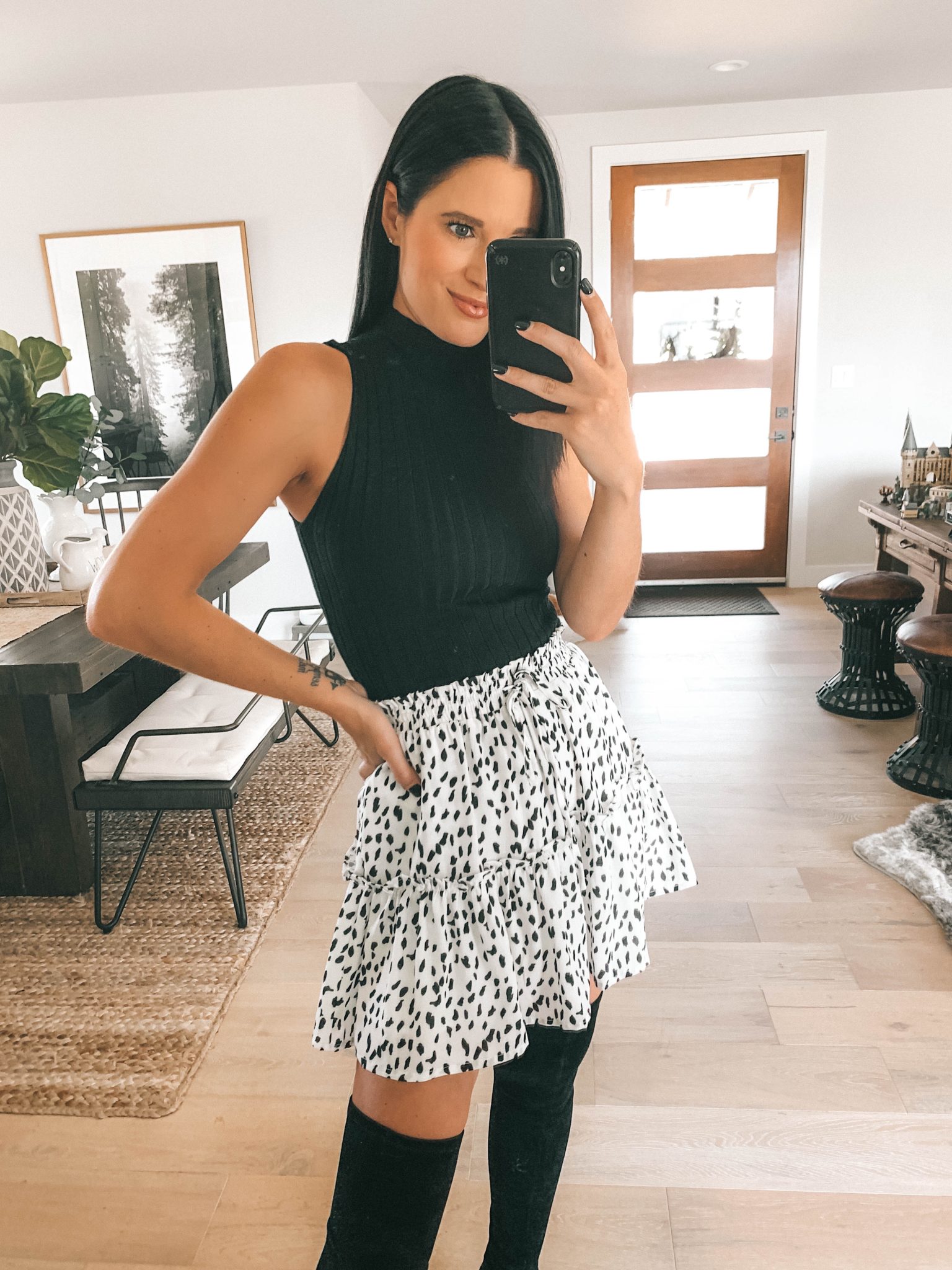 Transition Your Summer Looks Into Fall with Princess Polly Clothing by popular Austin fashion blog, Dressed to Kill: image of a woman wearing a Princess Polly black sweater tank, white with black dots mini skirt, and over the knee boots.