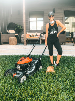 Honda Miimo Robotic Lawn Mower Review | If you're like me and love to mow the lawn, this robotic lawn mower will change the way you do lawn care! || Dressed to Kill #roboticlawnmower #lawnmower #lawncare | Honda Miimo Robotic Lawn Mower Review by popular Austin lifestyle blog, Dressed to Kill: image of woman standing next to her Honda HRX217HYA lawn mower.