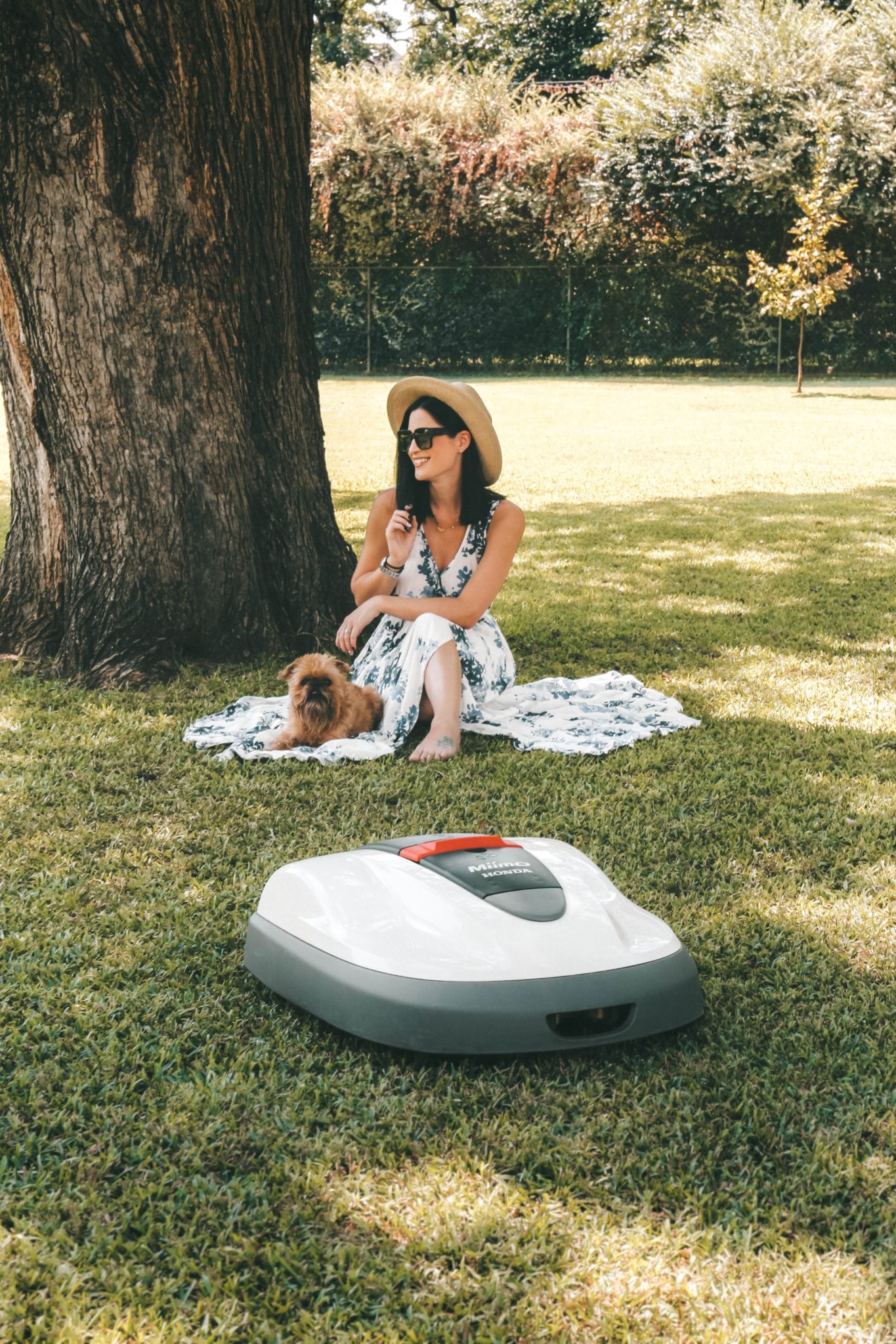 Honda Miimo Robotic Lawn Mower Review by popular Austin lifestyle blog, Dressed to Kill: image of woman and her dog sitting near the Honda Miimo Robotic Lawn Mower.