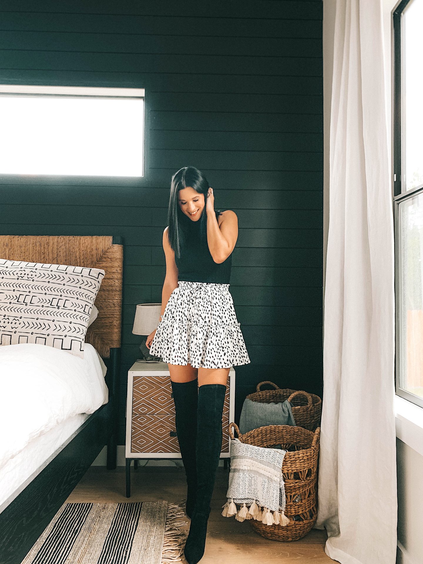 Transition Your Summer Looks Into Fall with Princess Polly Clothing by popular Austin fashion blog, Dressed to Kill: image of a woman wearing a Princess Polly black sweater tank, over the knee boots, and black and white dot mini skirt.