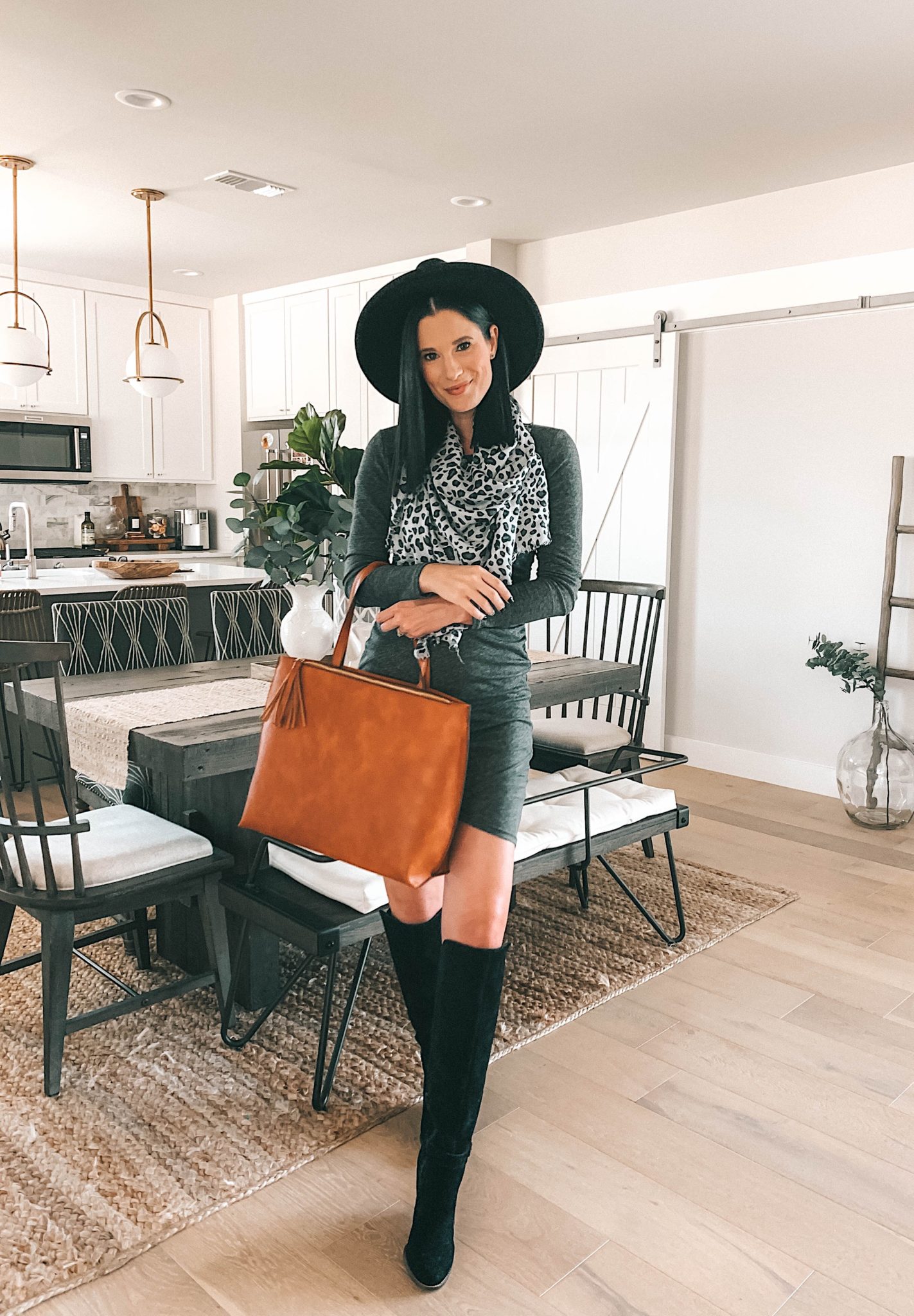 Must Have Sole Society Fall Staples by popular Austin fashion blog, Dressed to Kill: image of a woman wearing a grey rouched body-con dress, Sole Society Paloma Wedge Boots, leopard print oversized scarf, and holding a Wallis Tote. 
