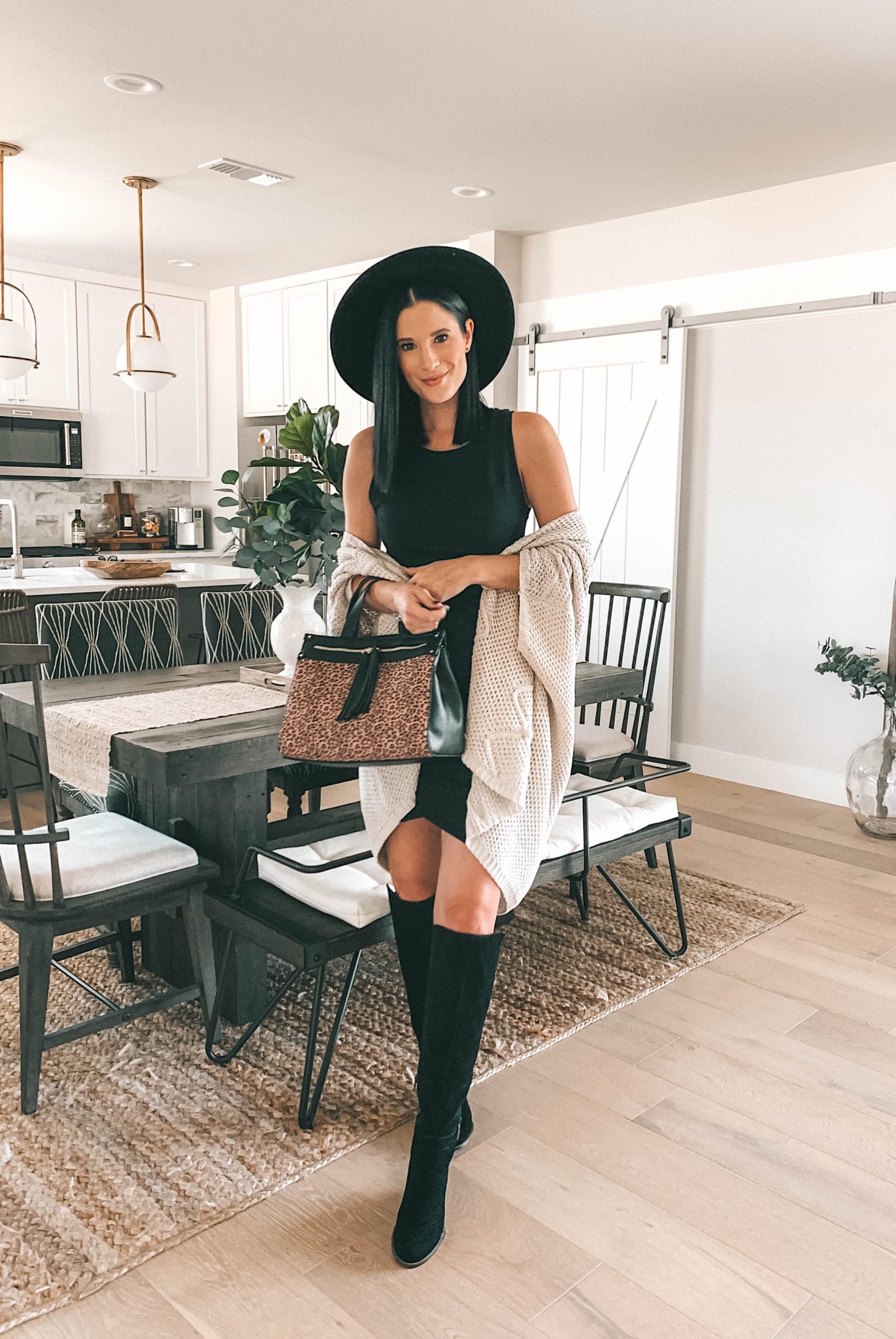 Must Have Sole Society Fall Staples by popular Austin fashion blog, Dressed to Kill: image of a woman wearing a black Nordstrom Leith rouched body-con dress, Sole Society Paloma wedge boot, Sole Society Knit Detail Wrap, and holding a Sole Society leopard print Zypa Satchel. 