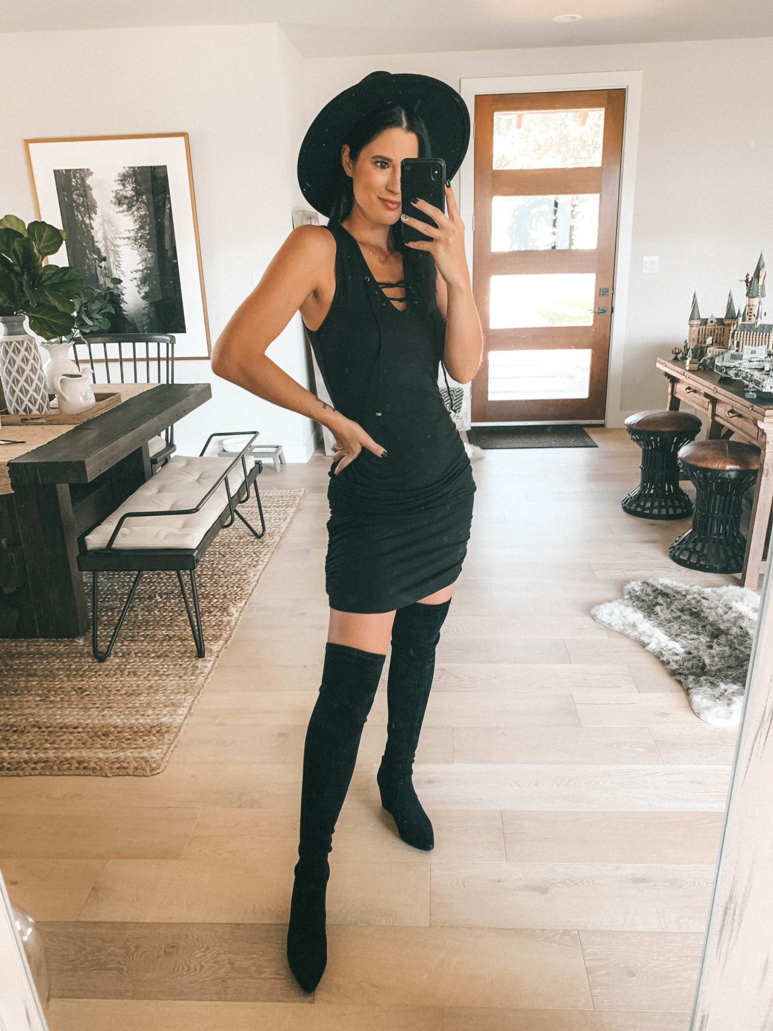 7 Affordable Fall Outfits from Walmart by popular Austin fashion blog, Dressed to Kill: image of a woman standing inside her house and wearing a black Walmart Mini Dress.