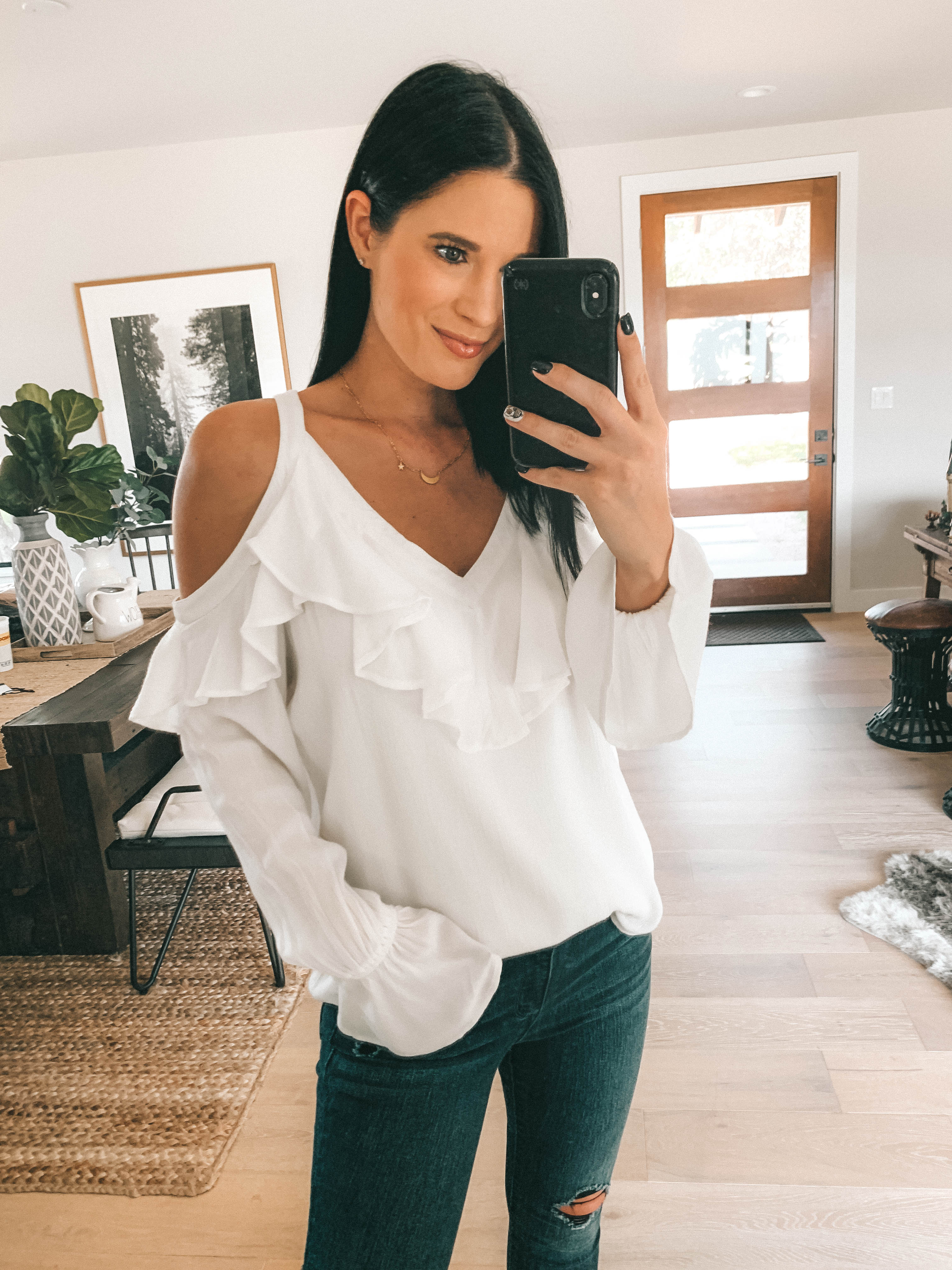 7 Affordable Fall Outfits from Walmart by popular Austin fashion blog, Dressed to Kill: image of a woman standing inside her house and wearing Sofia Jeans Cold-Shoulder Ruffle Neck Woven Top and Sofia Jeans Sofia Skinny Destructed Frayed Hem Mid Rise Ankle Jean.