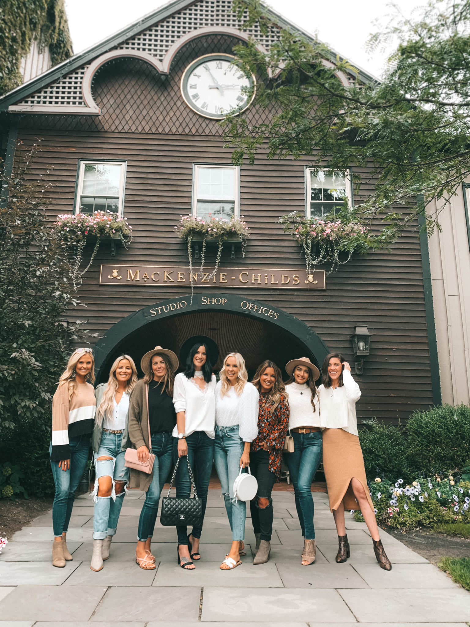 Decorating with MacKenzie Childs Fall Collection by popular Austin life and style blog Dressed to Kill: image of a group of girls standing outside of the MacKenzie Childs studio.