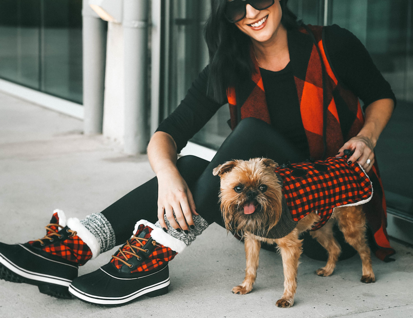 Matching Dog and Owner Outfits for the Holidays by popular Austin life and style blog, Dressed to Kill: image of an owner and her dog wearing an Amazon KIRJAUDU Womens Lapel Open Front Sleeveless Plaid Vest Cardigan with Pockets, Nordstrom Halogen Long Sleeve Modal Blend Tee, Nordstrom Spanx Faux Leather Leggings, Amazon GLOBALWIN Women's 1632 Black Grey Snow Boots, Bare Necessities BAREFOOT DREAMS COZYCHIC HEATHERED PLUSH SOCKS, and Chewy plaid sweater.
