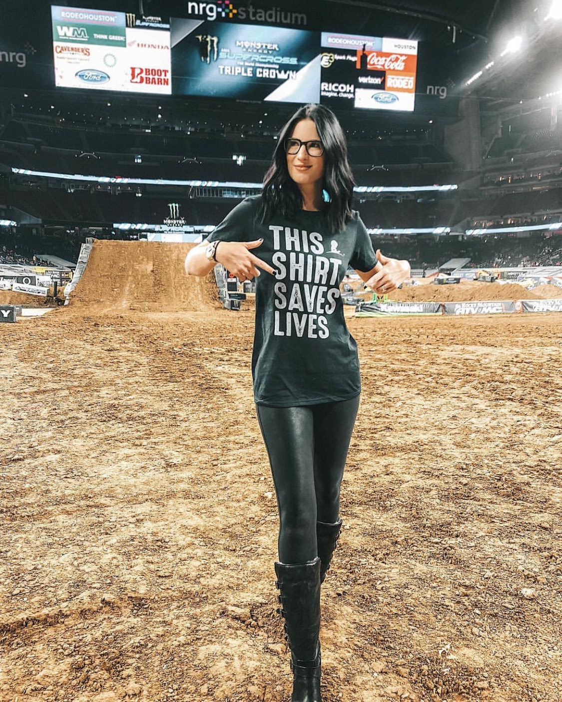 This Shirt Saves Lives by popular Austin lifestyle blog, Dressed to Kill: image of a woman wearing a St. Jude's This Shirt Saves Lives t-shirt and at a supercross venue. 
