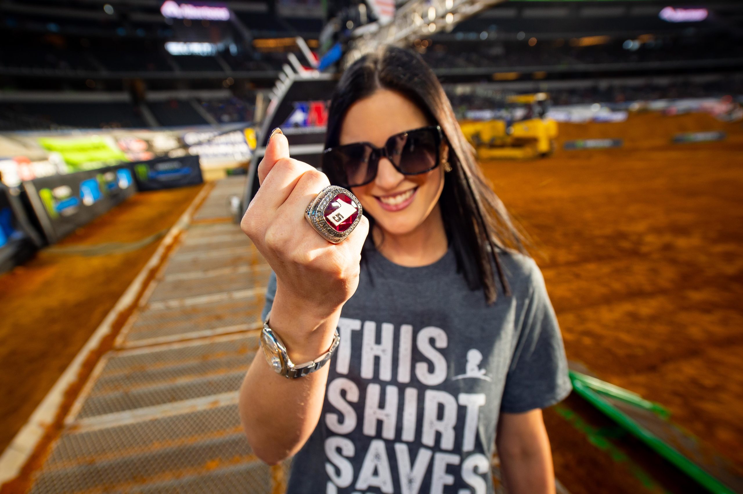 This Shirt Saves Lives by popular Austin lifestyle blog, Dressed to Kill: image of a woman wearing a St. Jude's This Shirt Saves Lives t-shirt and at a supercross venue. 