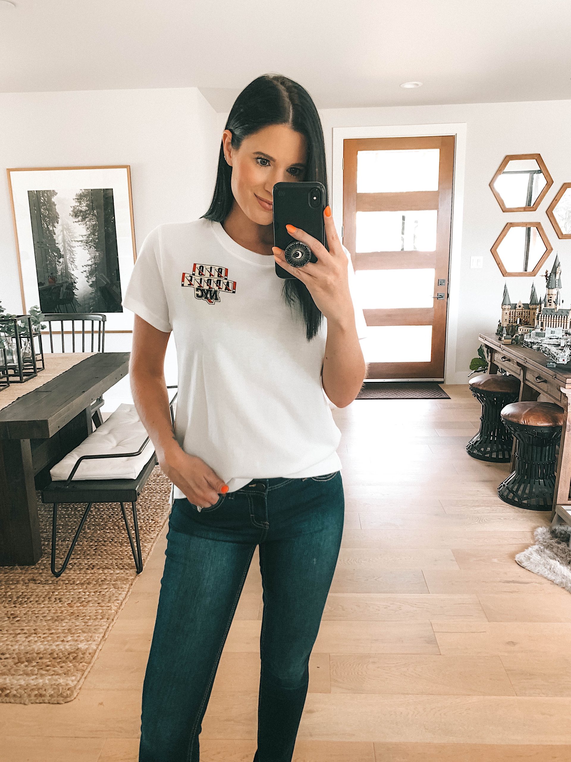 Walmart Jordache by popular Austin fashion blog, Dressed to Kill: image of a woman standing inside and wearing a Walmart Jordache VINTAGE Big Apple NYC shirt and jeans. 