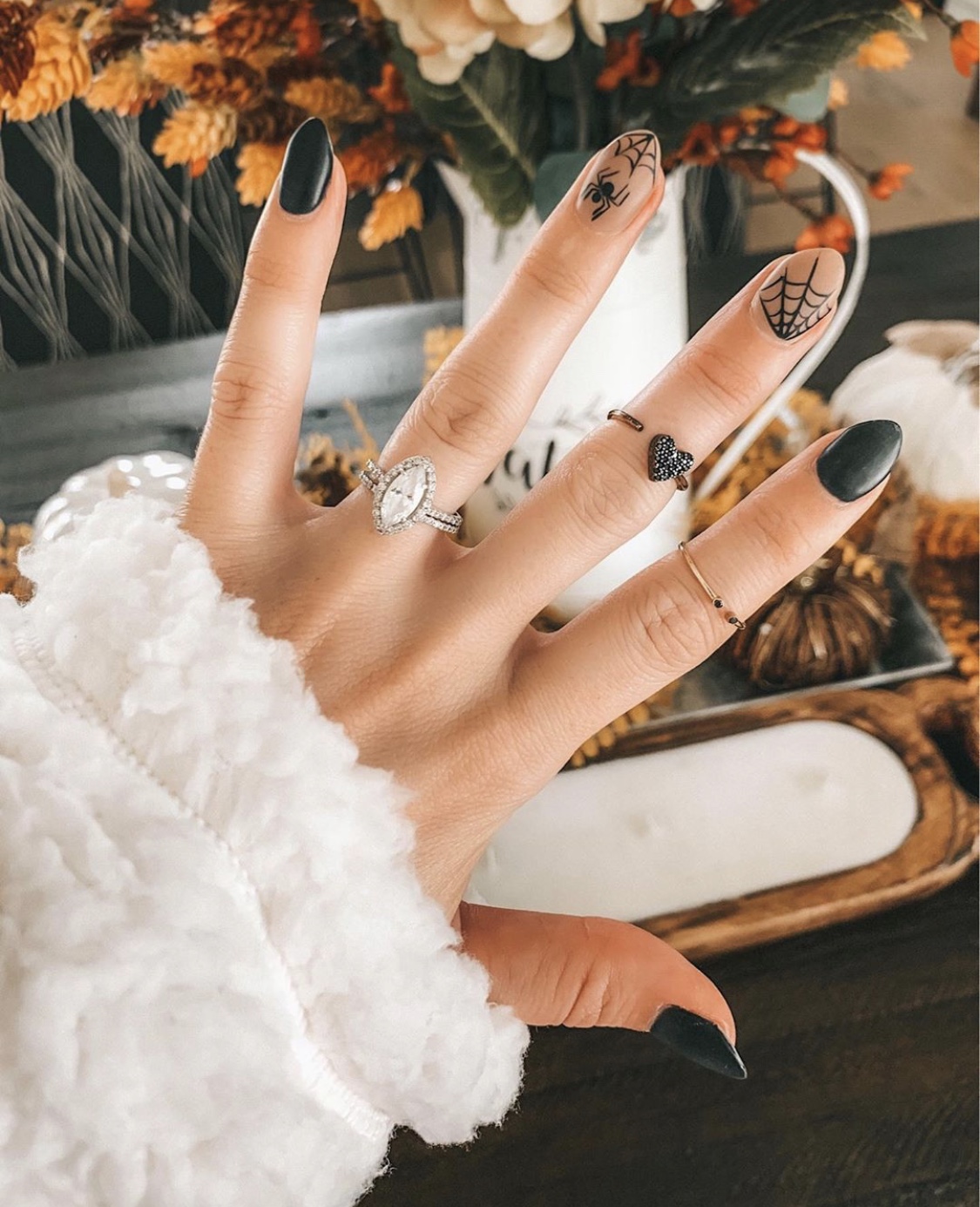 Nail Art Designs by popular Austin beauty blog, Dressed to Kill: image of a woman with spider design nail art and wearing Mejuri rings. 