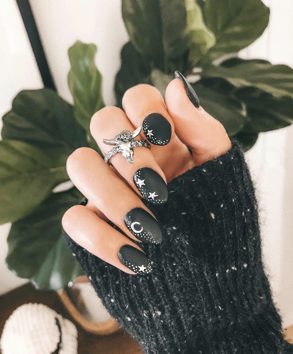 Nail Art Designs by popular Austin beauty blog, Dressed to Kill: image of a woman with black and white star and moon nail art and wearing a James Avery Long Horn Desert Rose ring. 