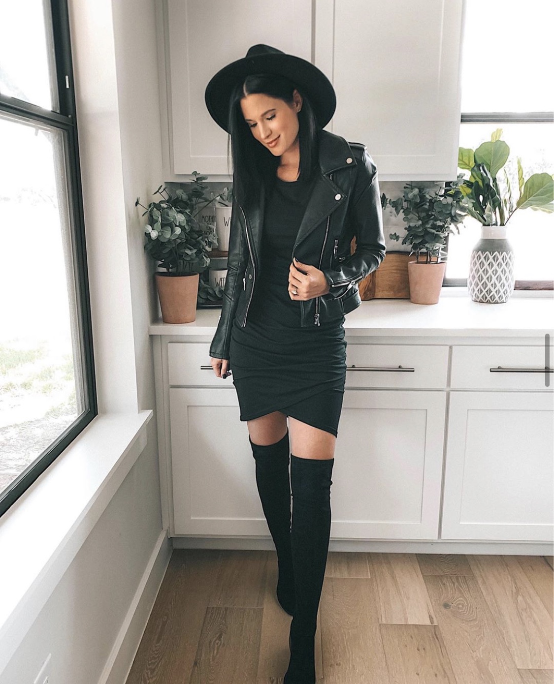 Nordstrom Anniversary Sale by popular Austin fashion blog, Dressed to Kill: image of a woman wearing a black faux leather jacket, black body con dress, flack felt fedora, and black over the knee boots. 